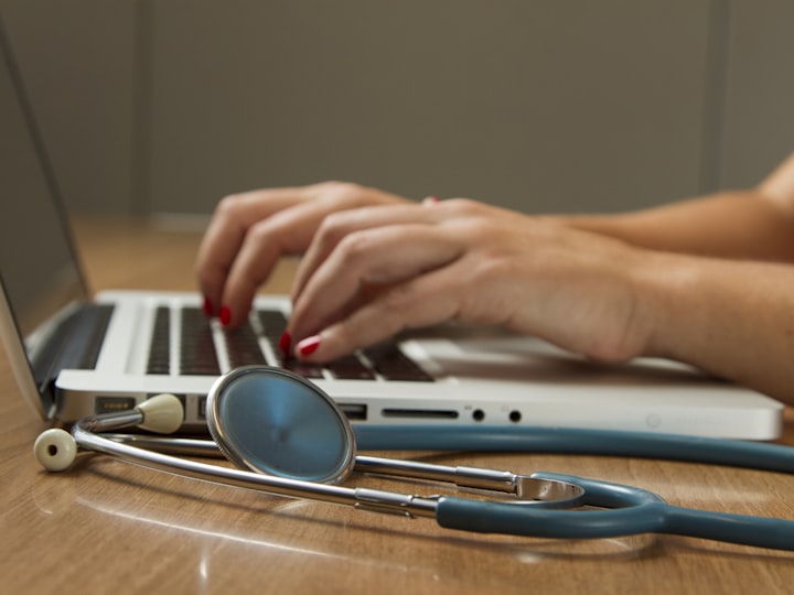 Clinical staff entering source data at a workstation